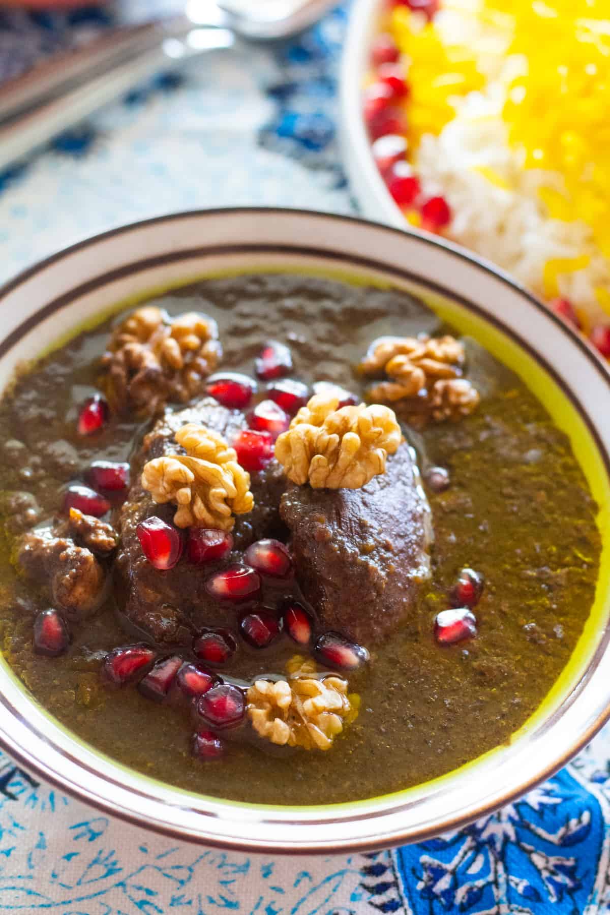 Fesenjan is a traditional Persian pomegranate and walnut chicken stew. It's sweet and sour with a rich nutty flavor and served over rice. The chicken is cooked in a rich walnut and pomegranate sauce until tender, making this a luscious and delicious meal. 