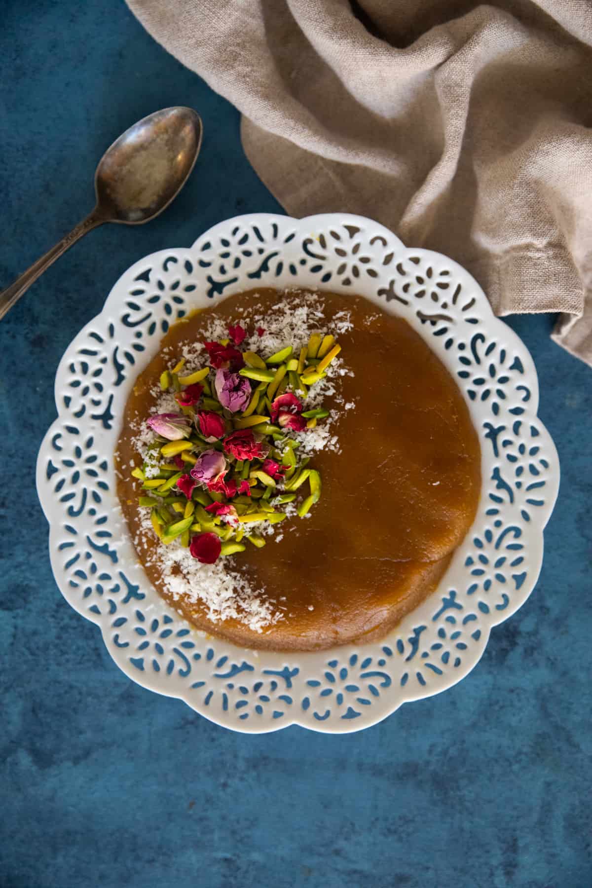 Persian halva on a plate on a blue backdrop.