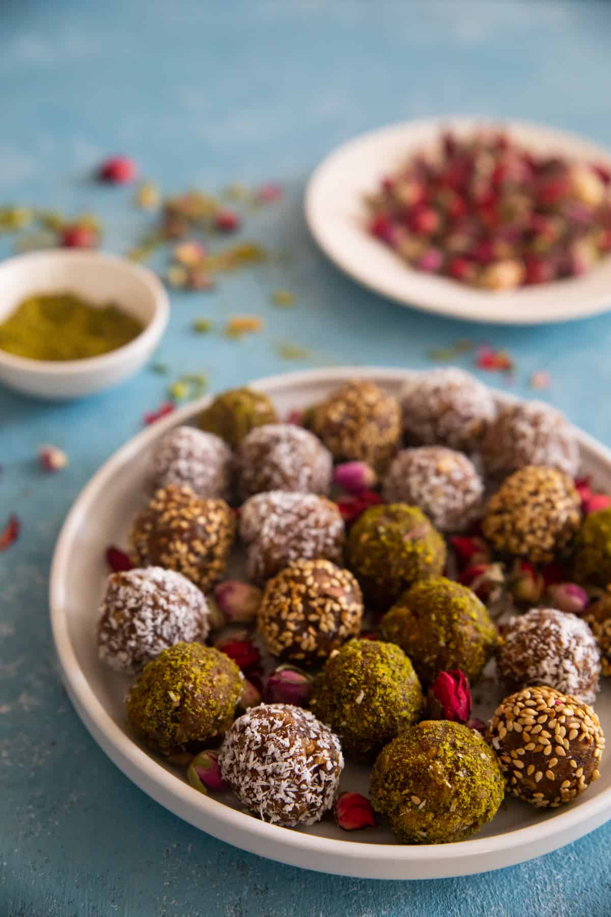 Date balls on a plate with rose petals. 