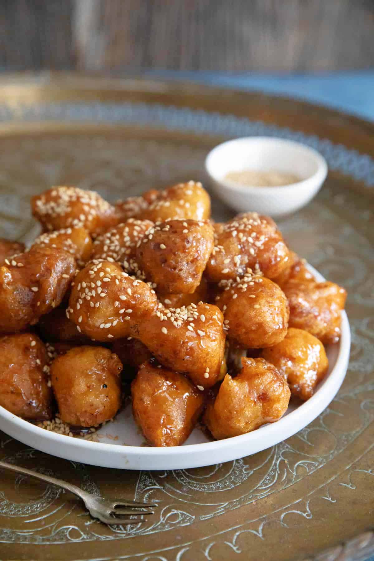 a plate of luqaimat in a golden tray. 