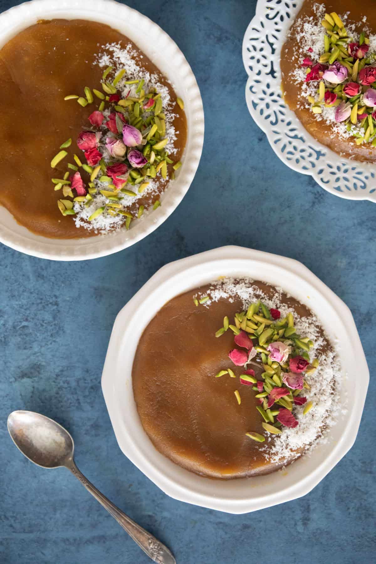 Three plates of halva on a blue backdrop.