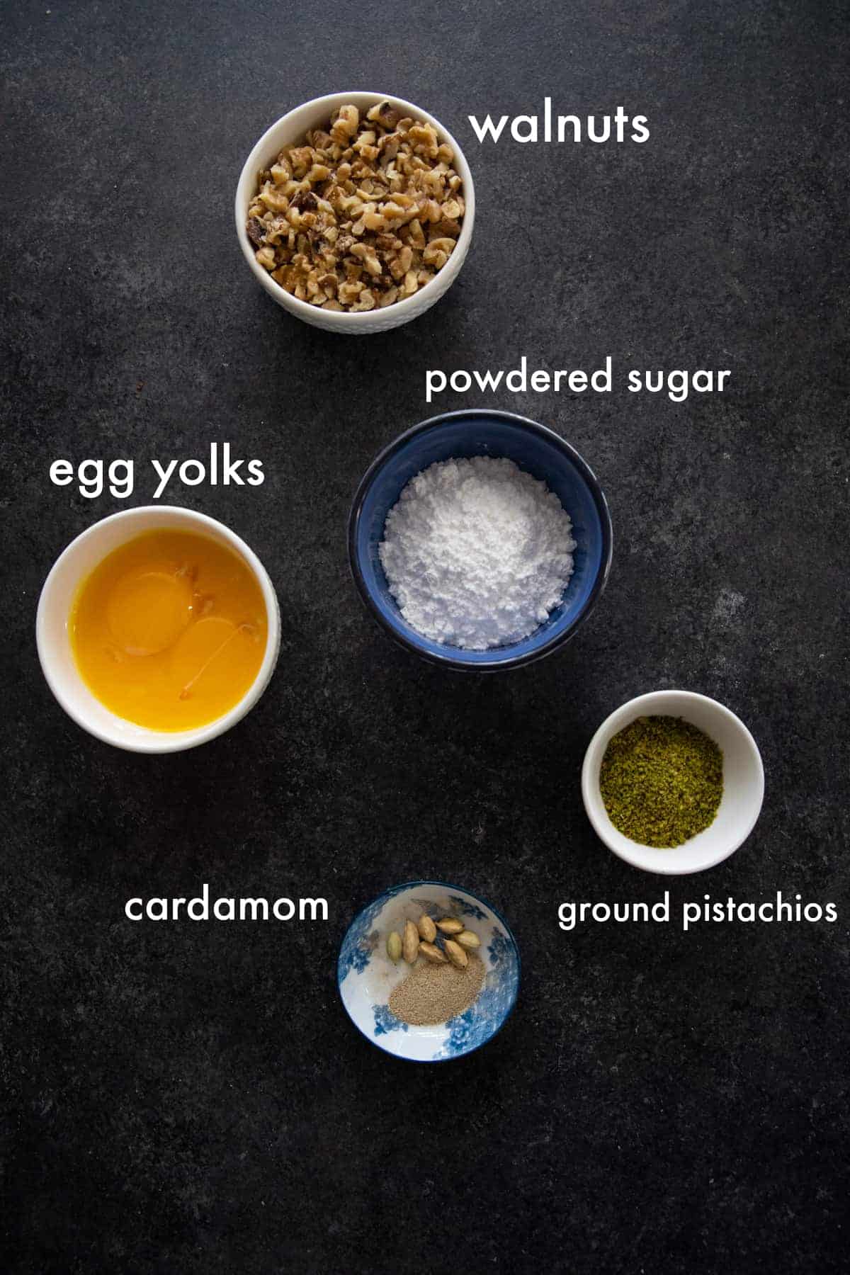 To make this recipe you need egg yolks, powdered sugar, vanilla, cardamom and walnuts. 