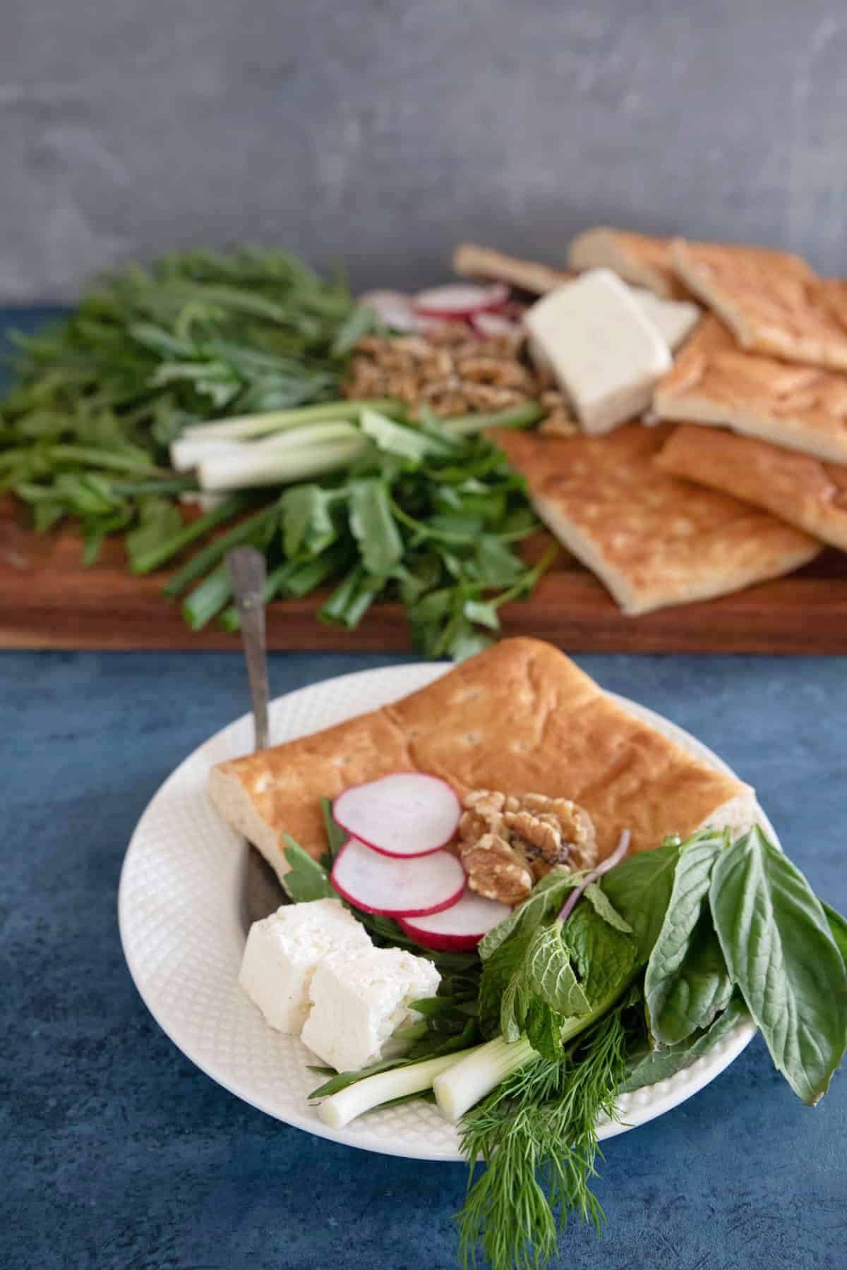 Serve Persian herb platter on a plate. 