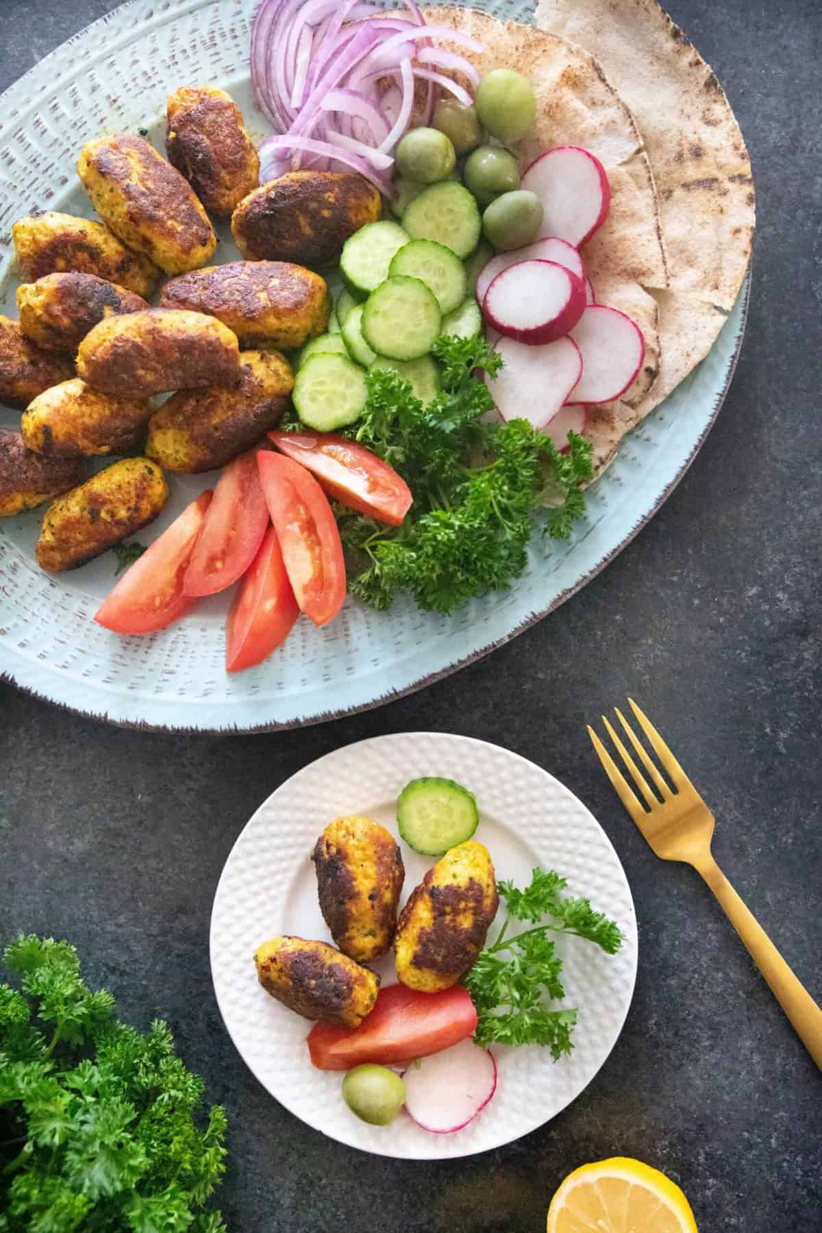 Serve chicken meatballs with vegetables and bread. 