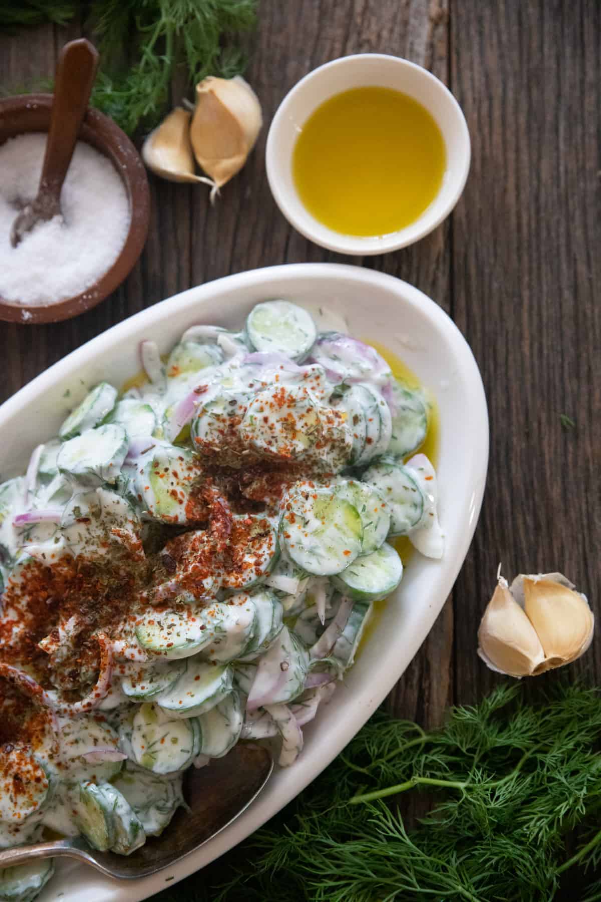 Light Creamy Cucumber Salad Cucumber salad with yogurt on a table.