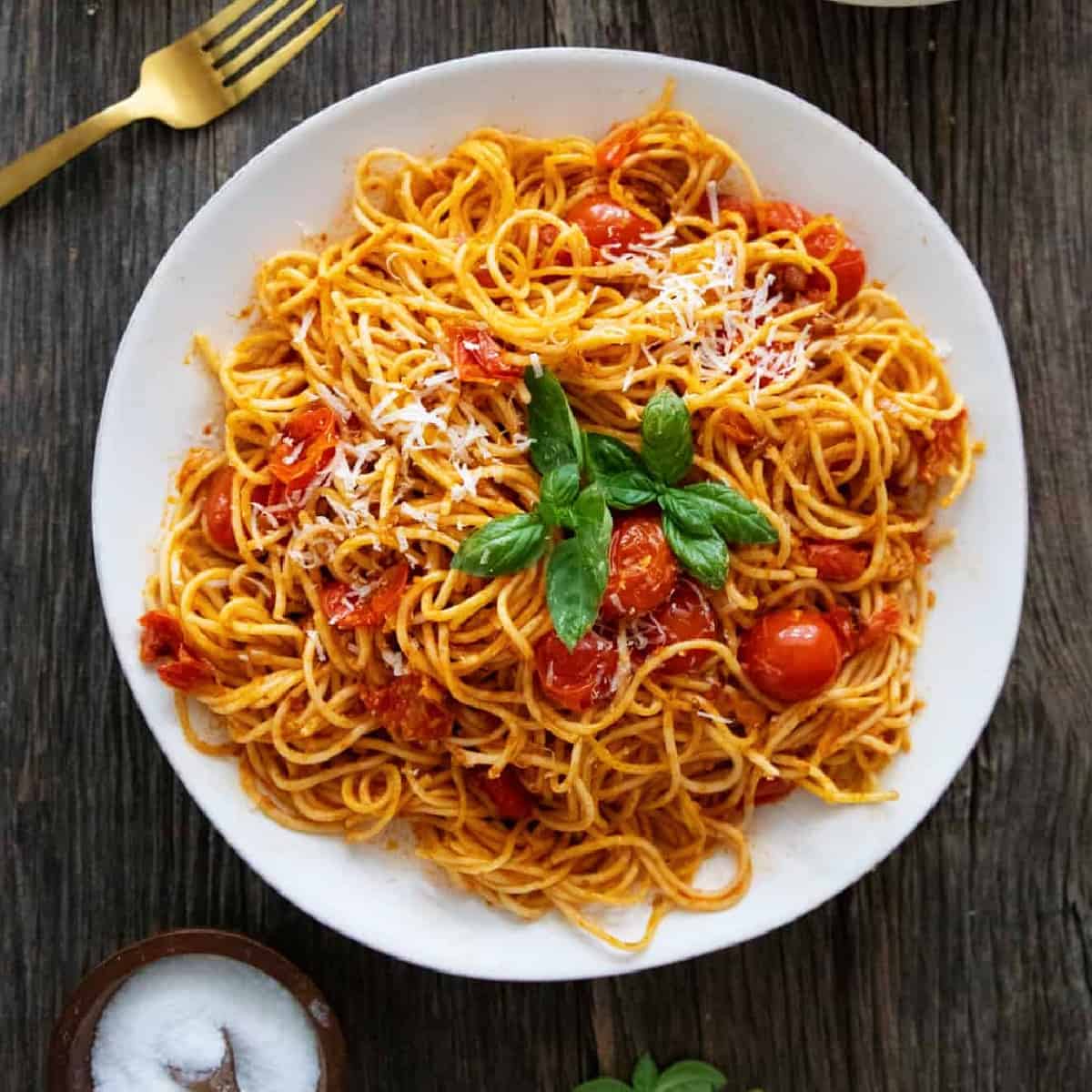 Cherry tomato pasta on a white plate.