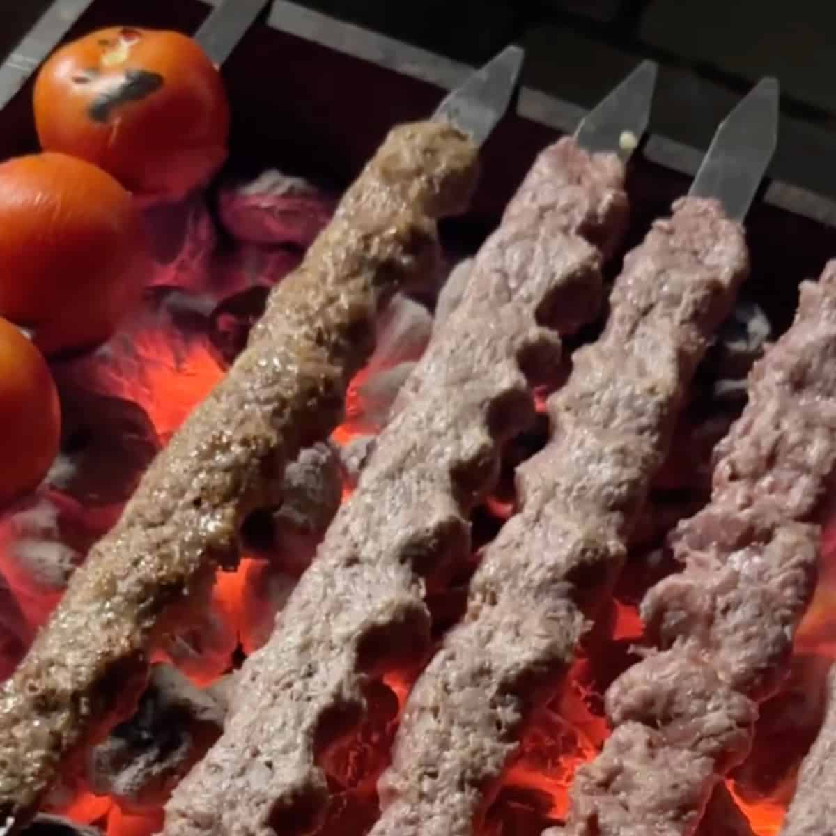 Preheat the grill until the charcoal is uniformly glowing and partially covered with ashes, or until the grill reaches a very high temperature to ensure the meat sticks to the skewers. Have a pot with a lid and some lavash nearby.