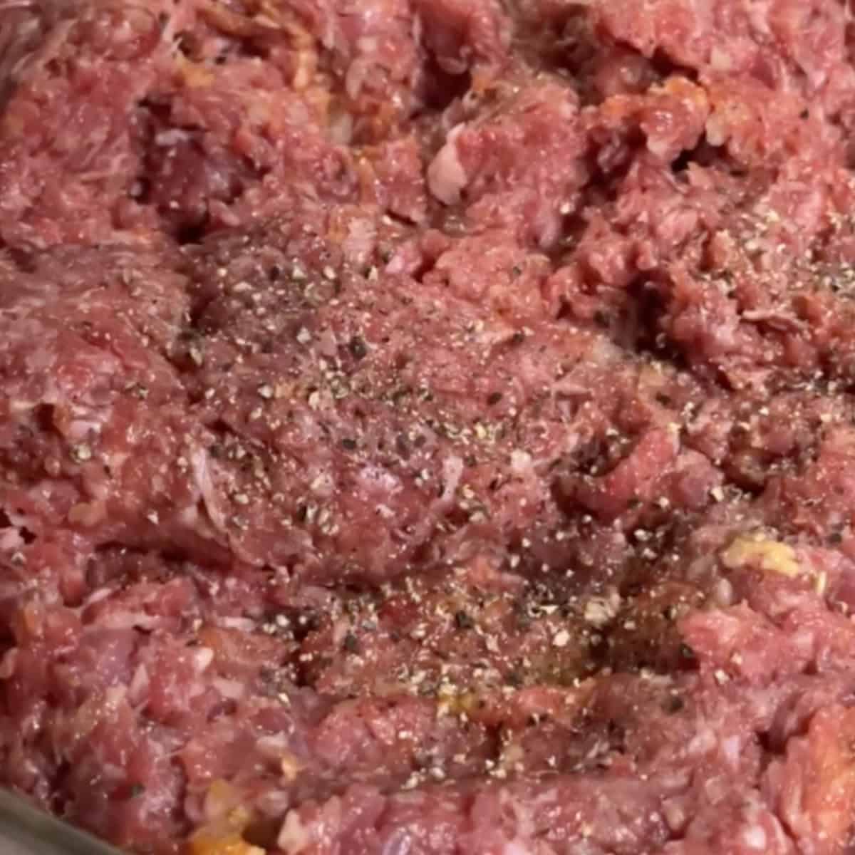 Add bloomed saffron, salt, and pepper to the meat and onion mixture. Knead the mixture by hand for an additional 10 minutes. Cover the mixture and refrigerate for one hour.