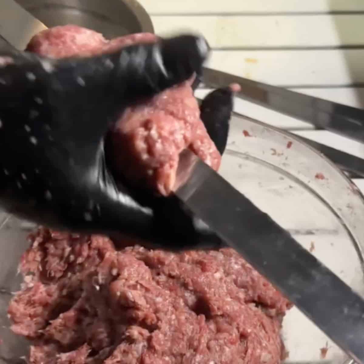 When ready to grill, remove the mixture from the fridge and keep a bowl of warm water nearby to prevent sticking. Take a handful of the mixture and shape it into an oval ball. Press the ball onto a 1-inch wide skewer. Wet your hands again and use your fingers to spread the meat along the skewer, forming a 6-inch long kebab with a thickness of ¼ to ½ inch on each side.