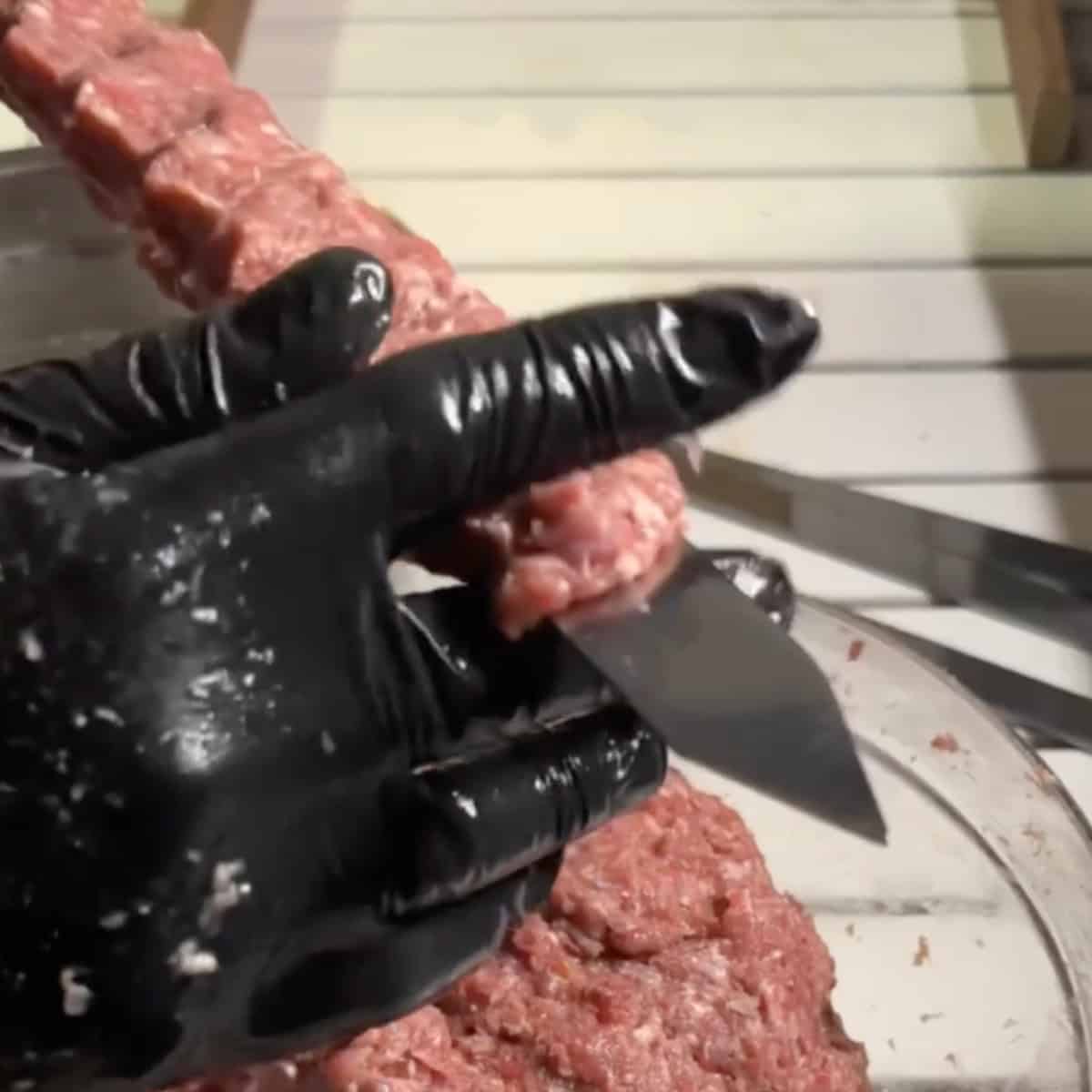Create indentations from top to bottom using your thumb and index finger to ensure the meat sticks to the skewer. Using your index and middle finger, remove a small piece from each end of the meat on the skewer to secure it completely. Repeat these steps with the remaining meat and skewers until all kabobs are formed.