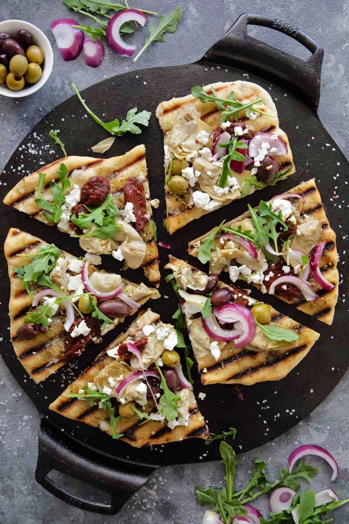 grilled pizza on a black surface.