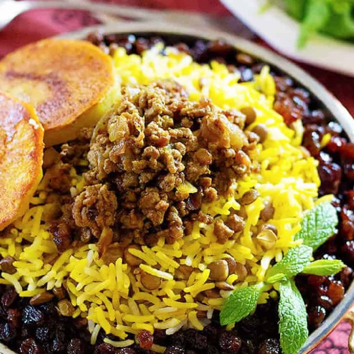 Adas Polo - Persian Lentil Rice is perfect for a weeknight meal. Rice and lentils served with delicious beef and raisins make the perfect healthy meal!
