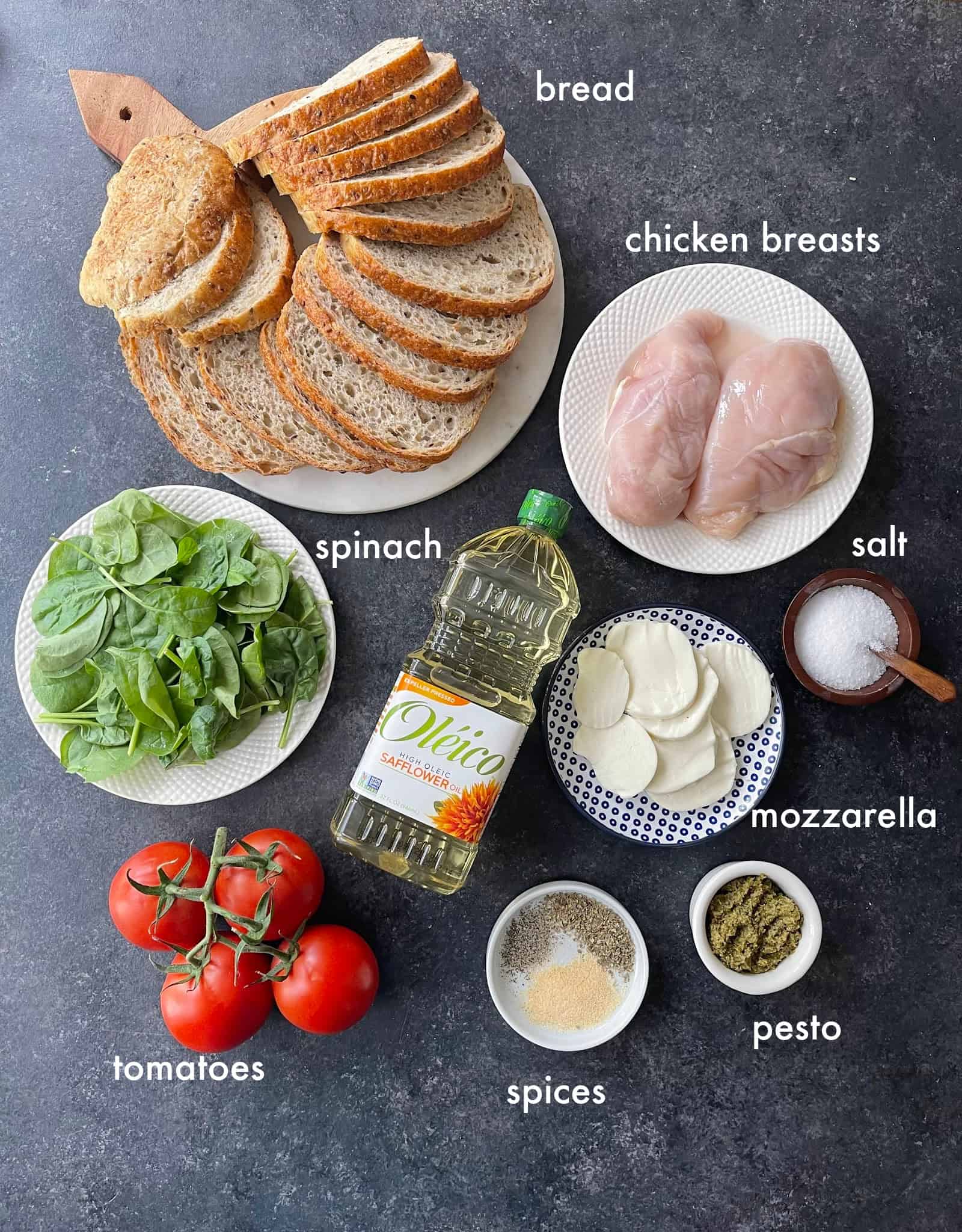 To make this recipe you need chicken, pesto, oil, bread, spinach, pesto, tomatoes and cheese. 