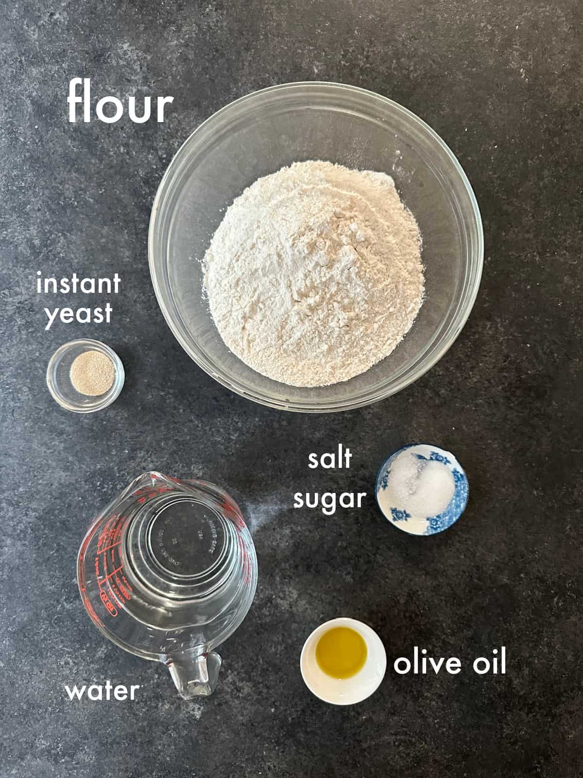 To make this recipe you need flour, salt, sugar, yeast, water and olive oil. 