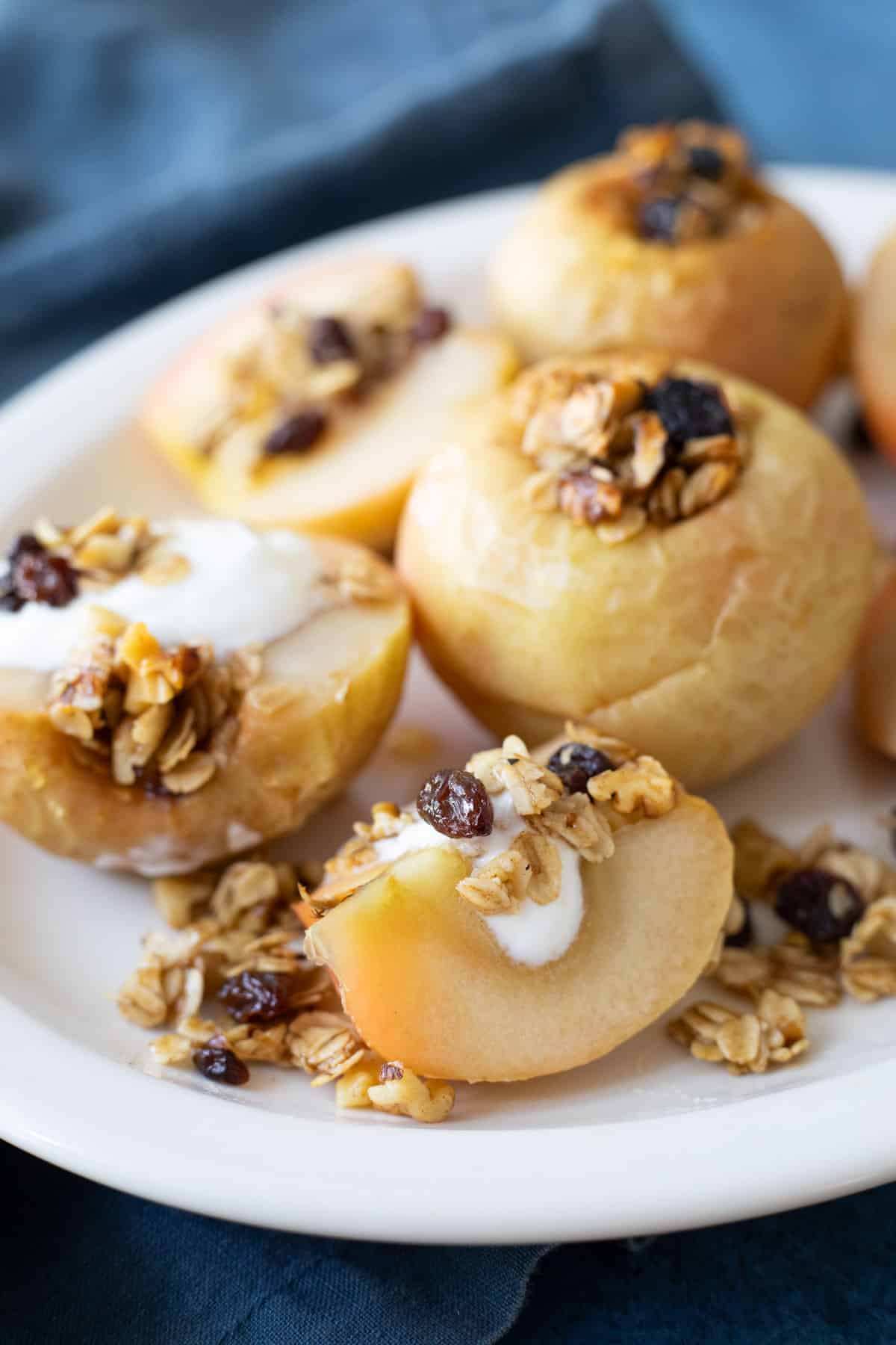Whole and sliced baked apples on a platter. 
