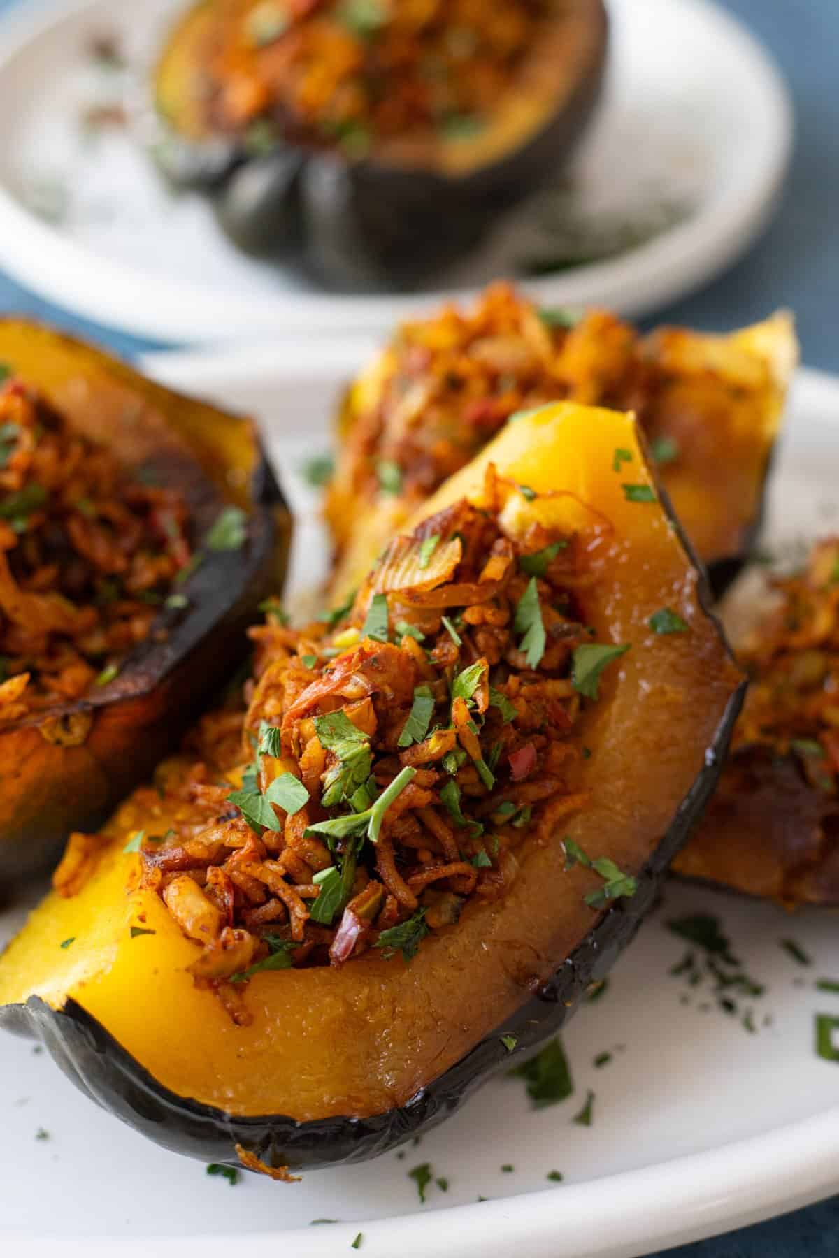 Front shot of roasted acorn squash filled with spiced rice.