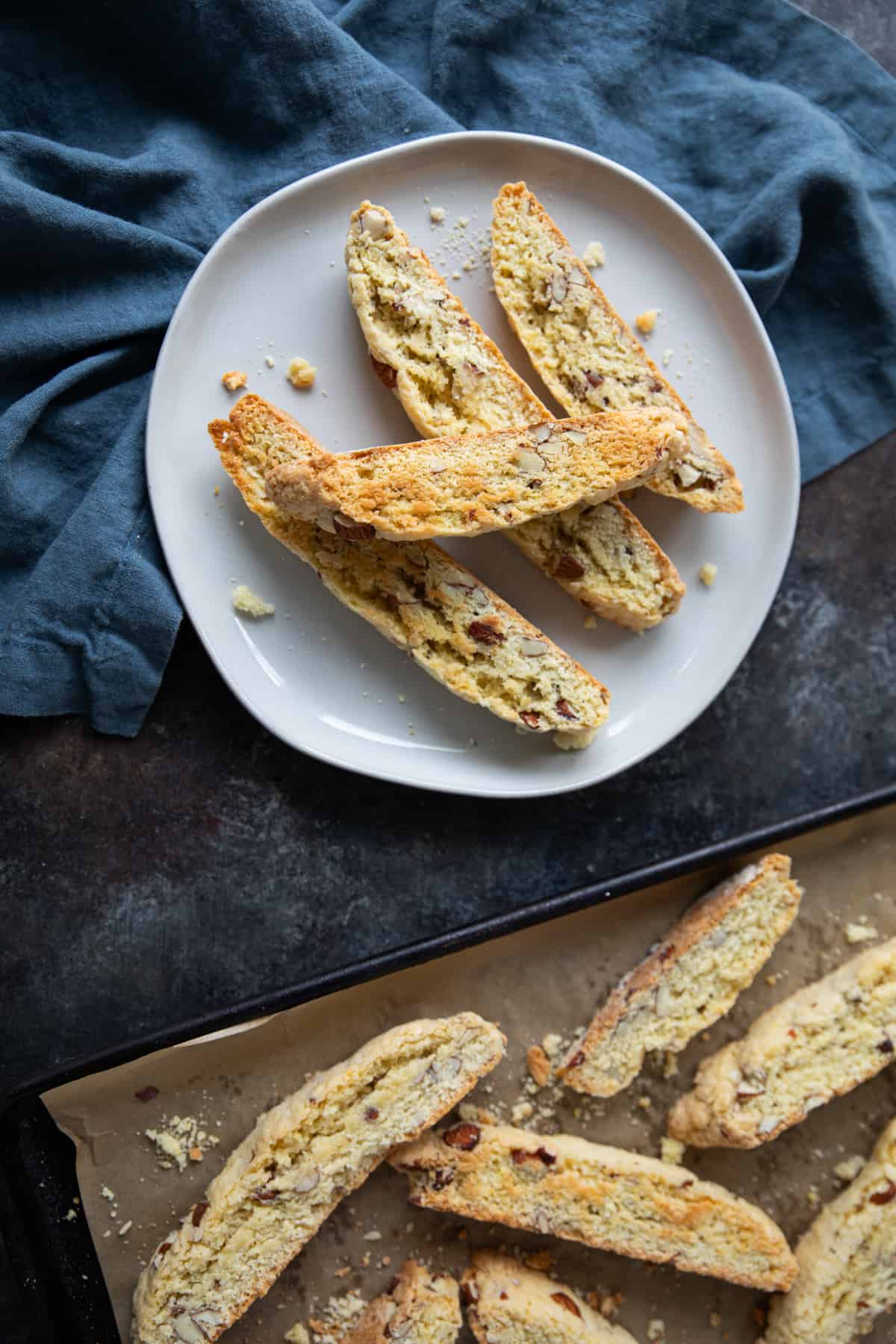 Biscotti on a plate and on baking sheet. 