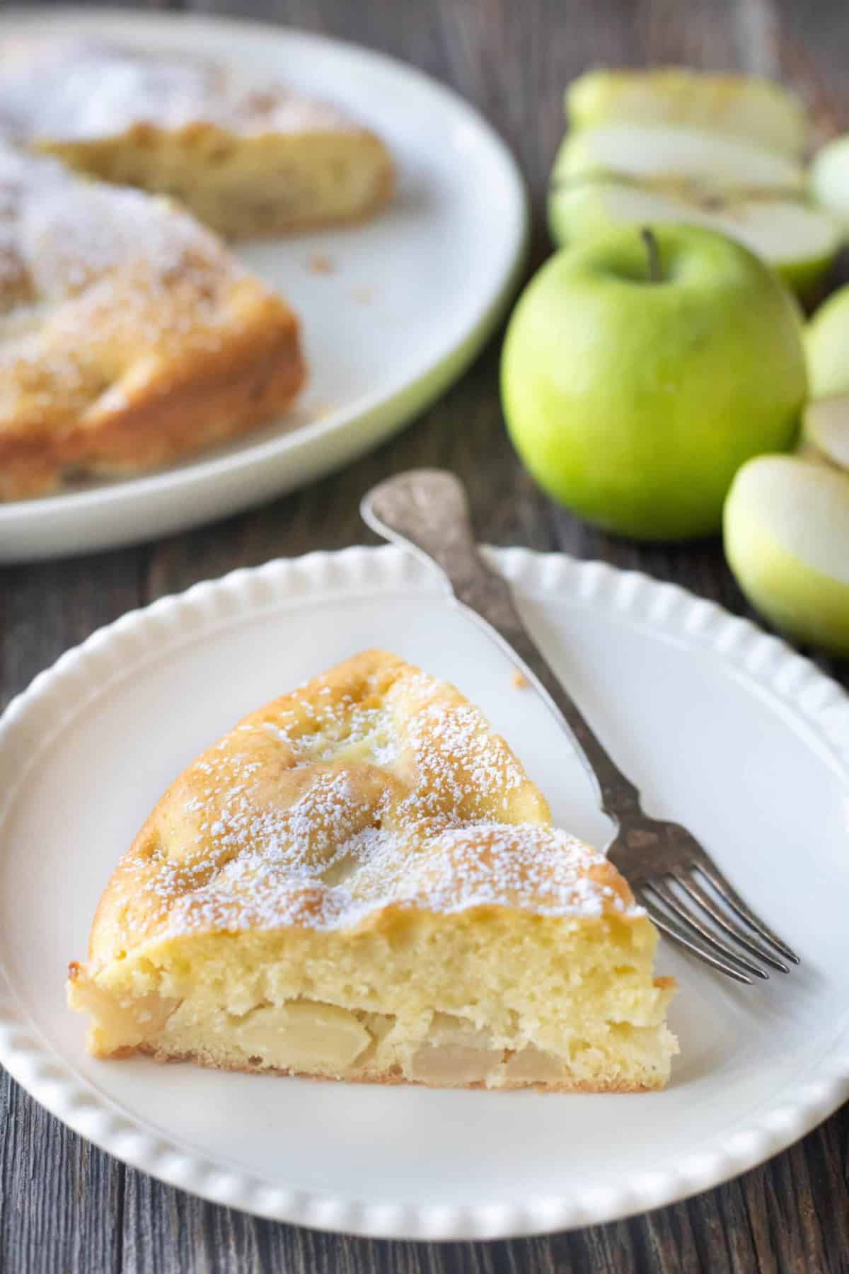A slice of French apple cake on a plate. 
