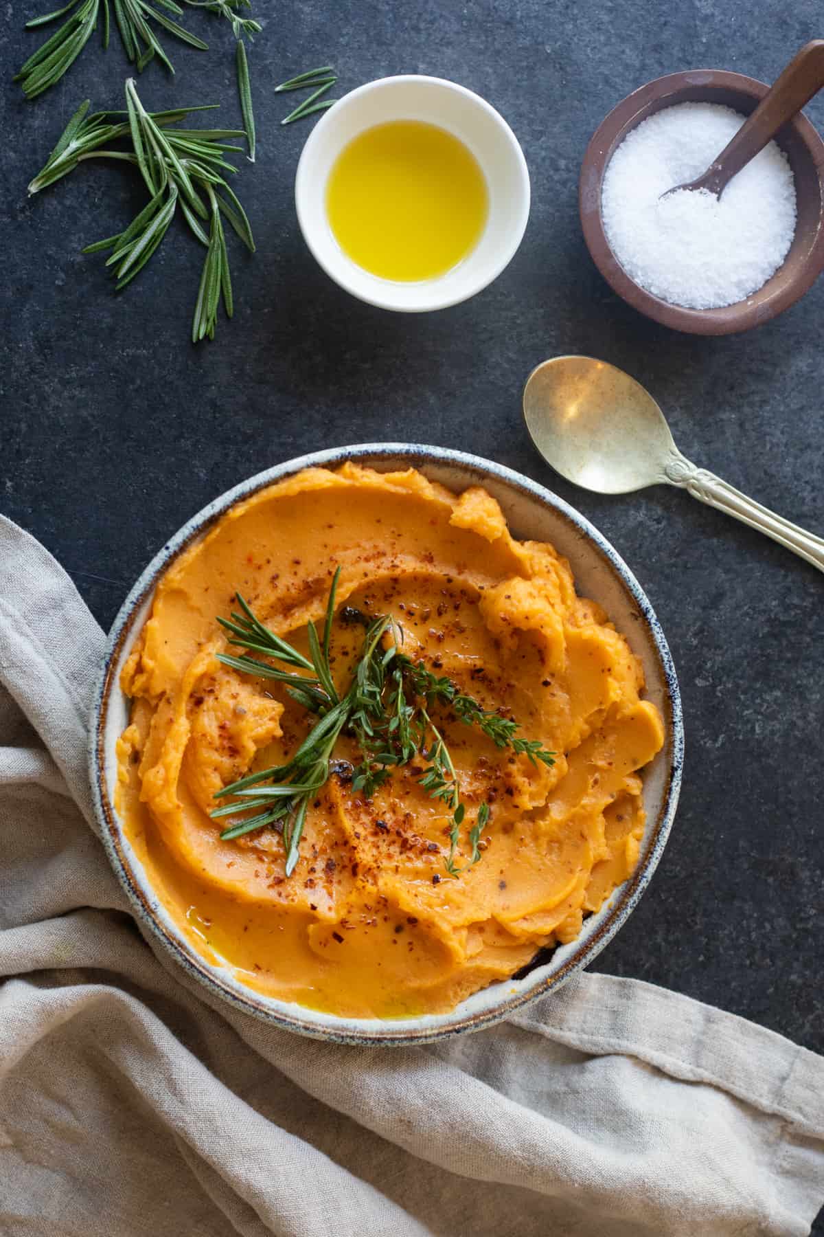 Sweet potato mash on a black surface. 