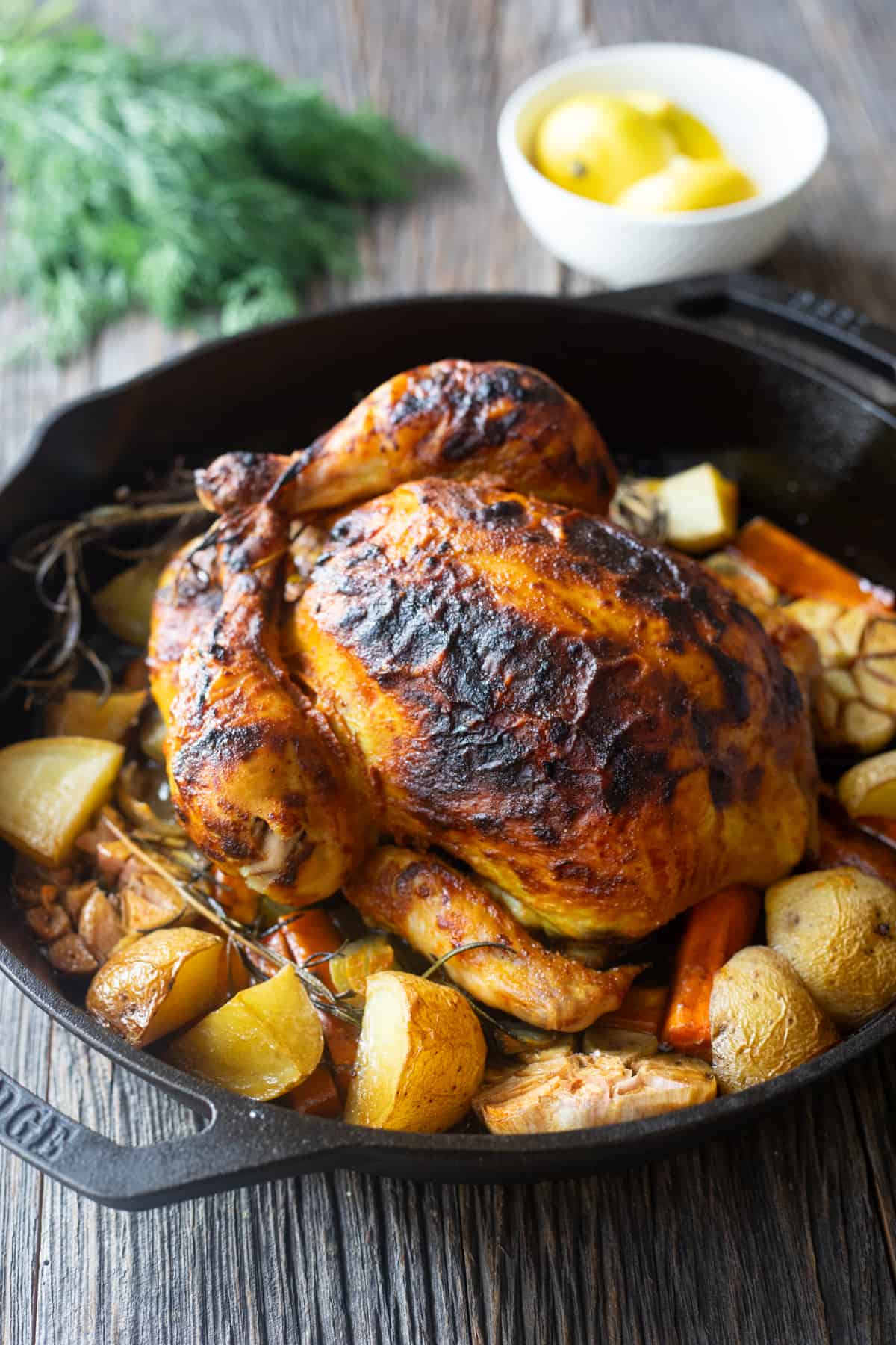 Whole roasted chicken in a cast iron skillet. 