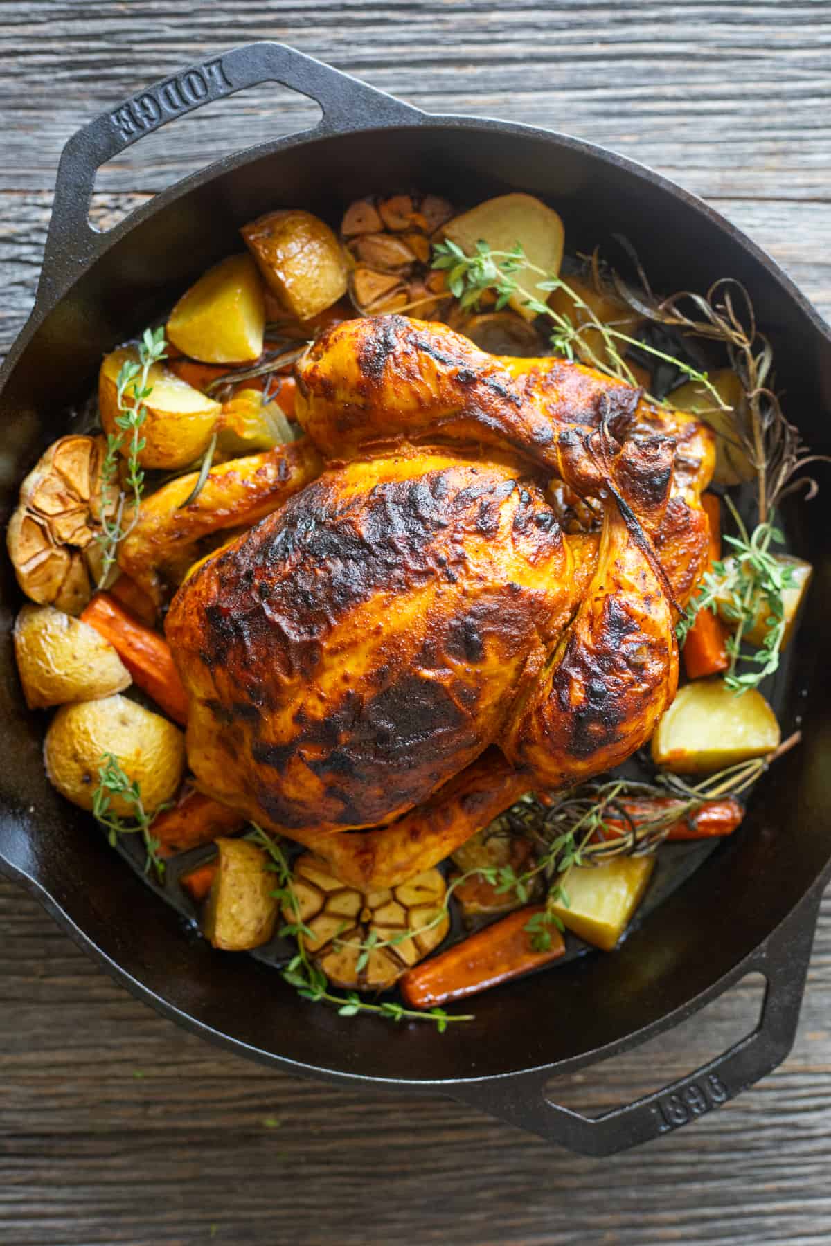 Roasted chicken and vegetables in a skillet.