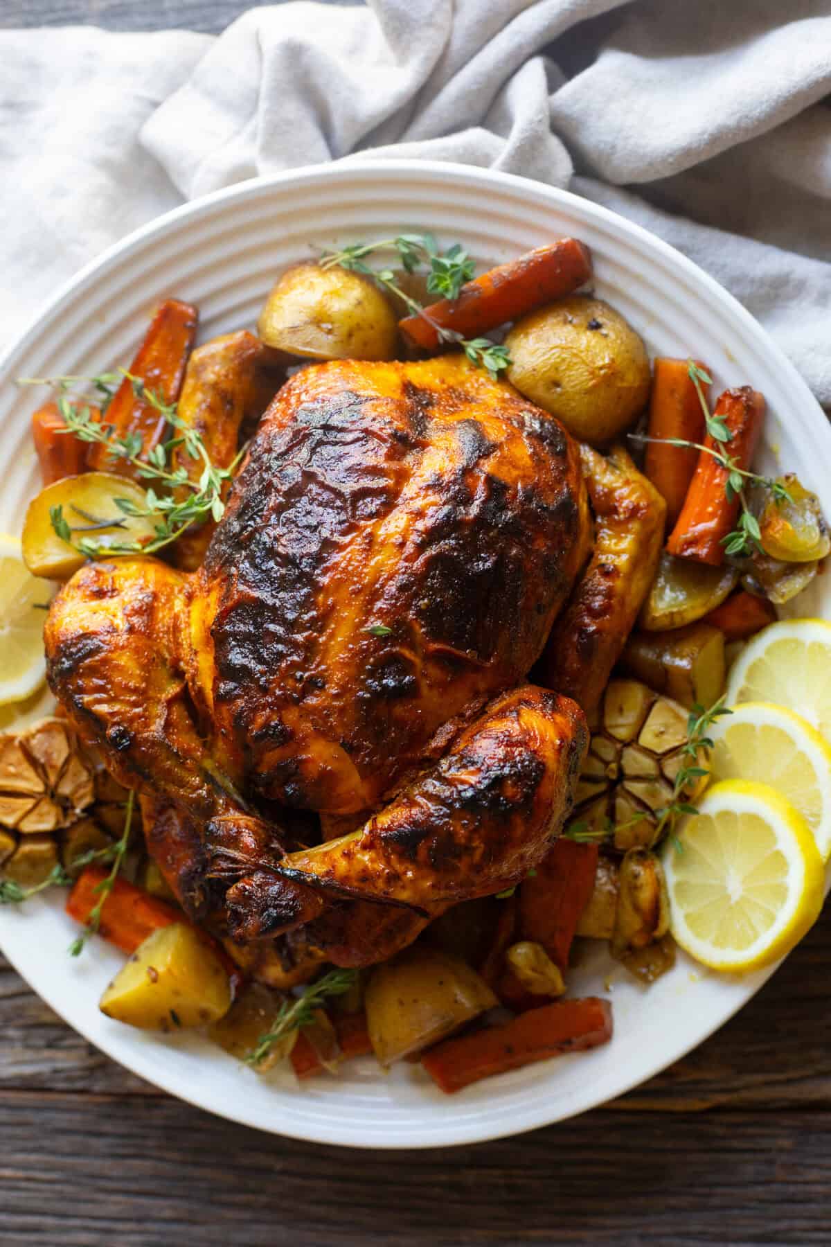 Overhead shot of a roast chicken on a platter. 