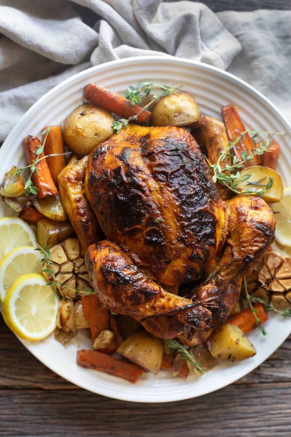 Overhead shot of a roast chicken on a platter. 