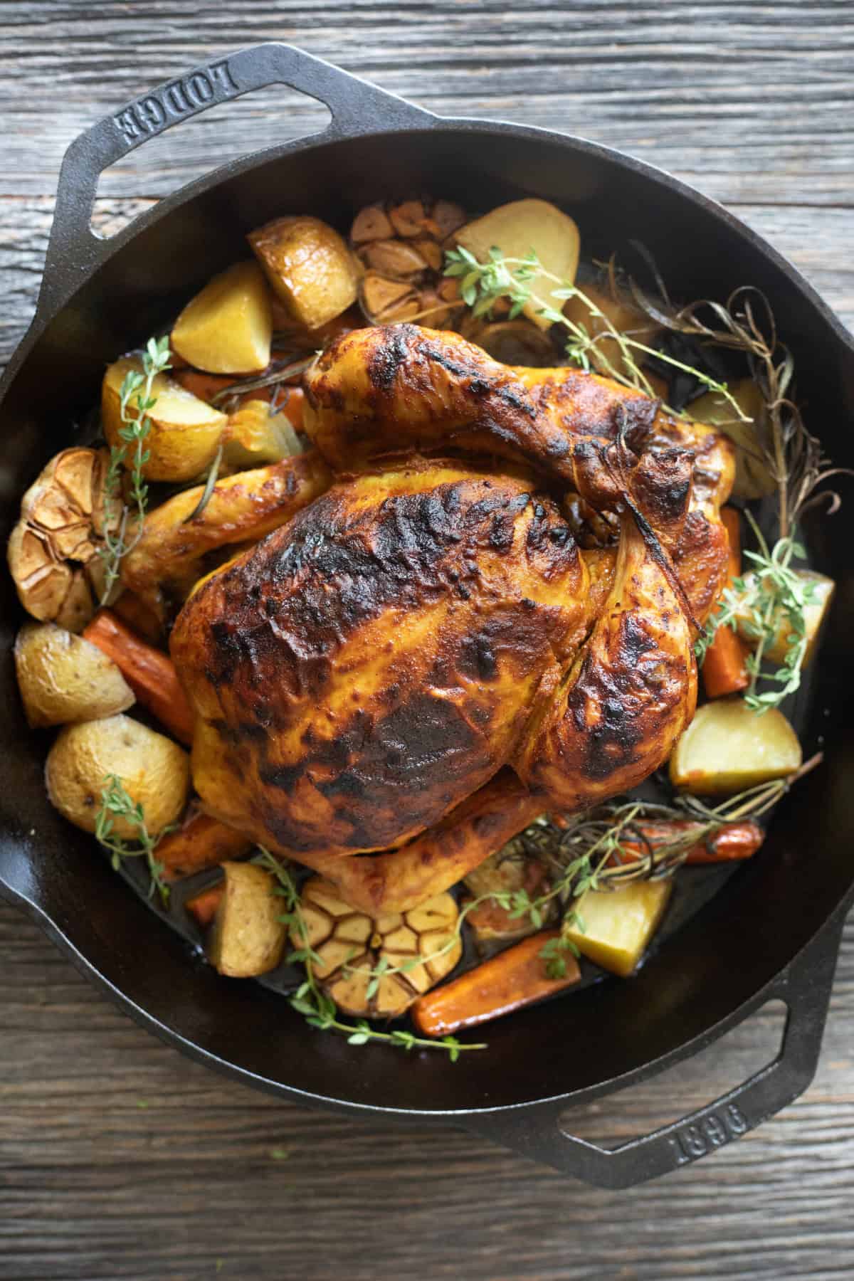 Roasted chicken and vegetables in a skillet.
