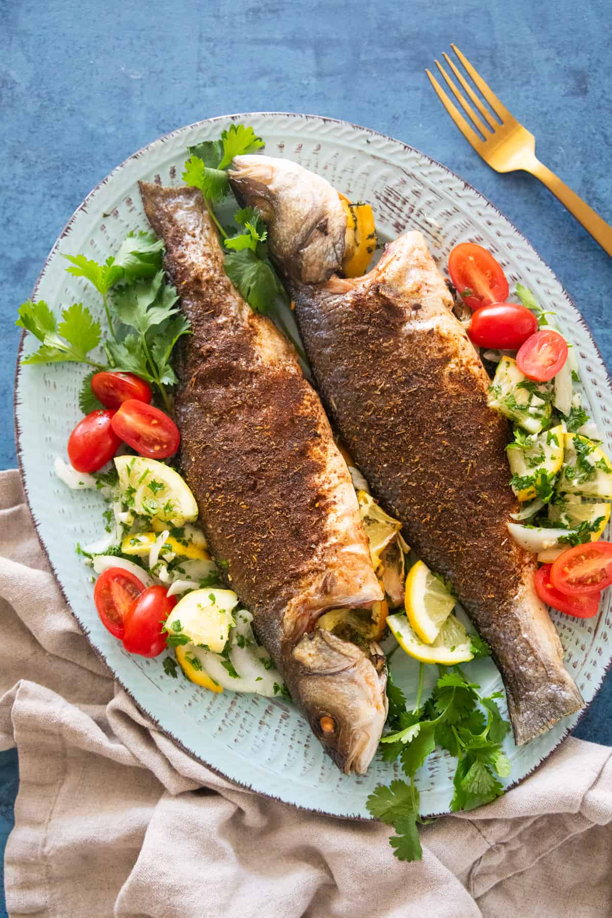 Overhead shot of roasted branzino on a platter. 