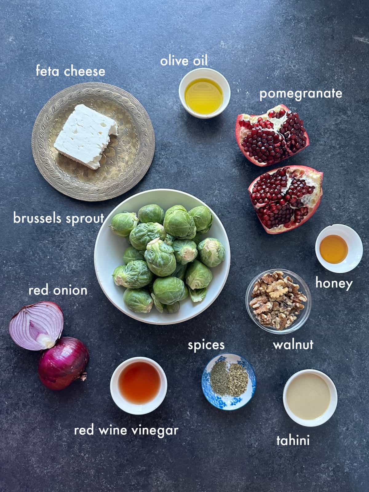 To make this salad, you need brussels sprouts, olive oil, tahini, vinegar, honey, spices, walnuts, red onions and feta.