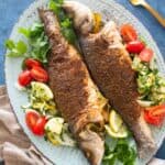 Roasted branzino with aromatics and spices! This simple branzino recipe comes together in no time and is perfect as a weeknight dinner or to impress your guests. Roasting a whole branzino is a lot easier than what you might think. The lemon adds a lot of flavor to the fish, you can serve it with rice, potatoes or a fresh salad.