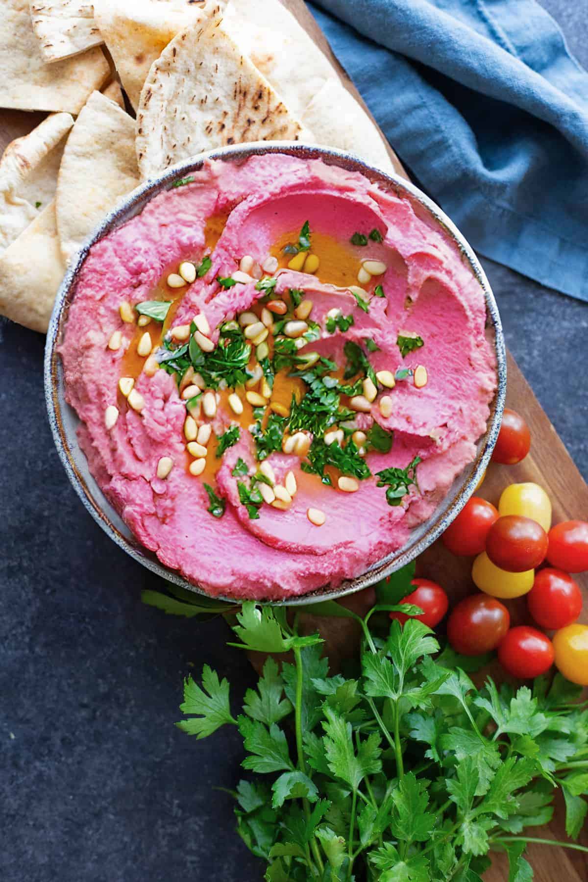 overhead shot of pink hummus in a bowl. 