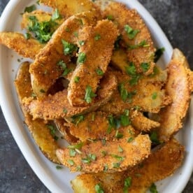 Parmesan potatoes are delicious and easy to make. The potatoes are cooked on a bed of seasoned grated parmesan, making them crispy and irresistible!
