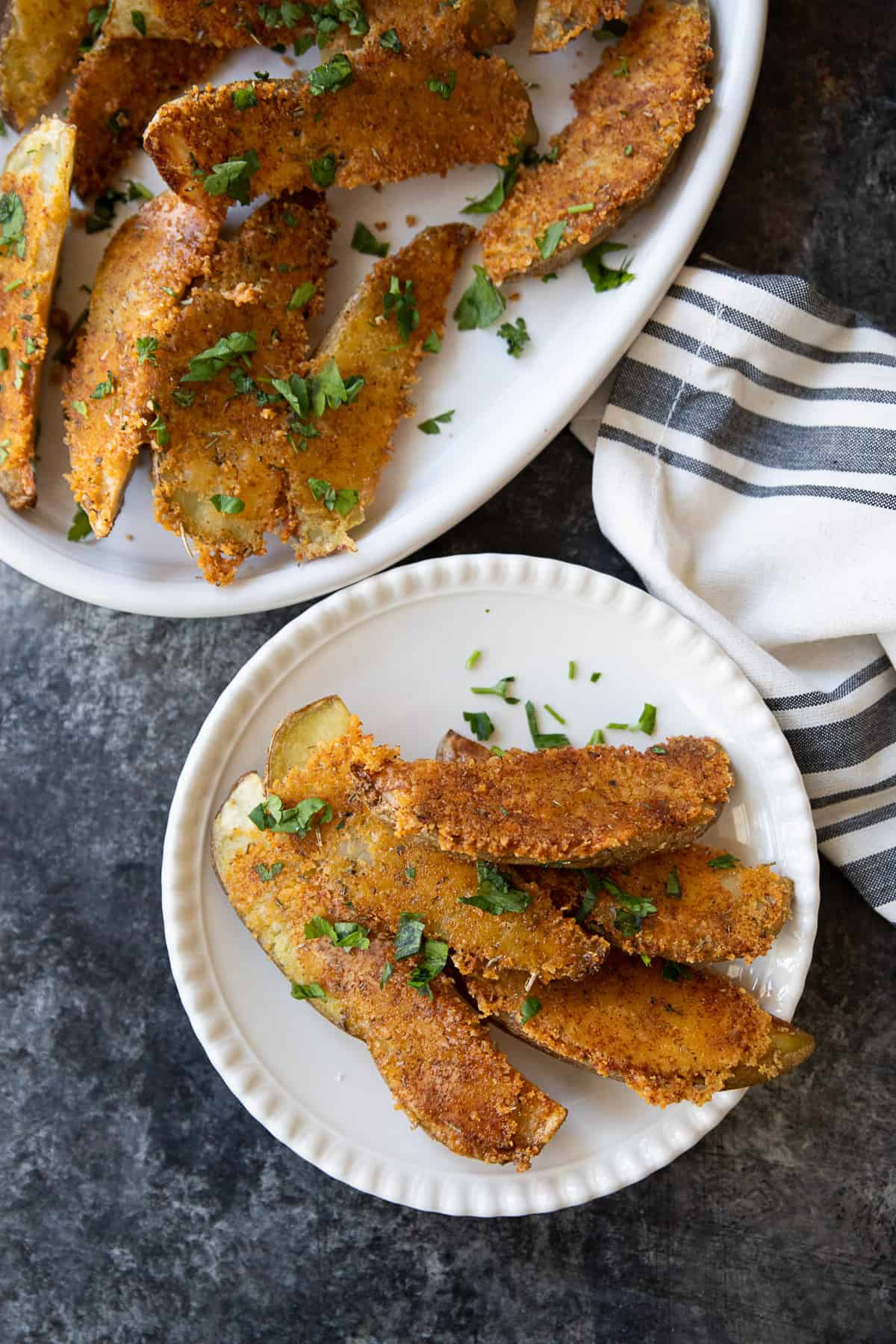 Overhead shot of parmesan crusted potatoes on a plate. 