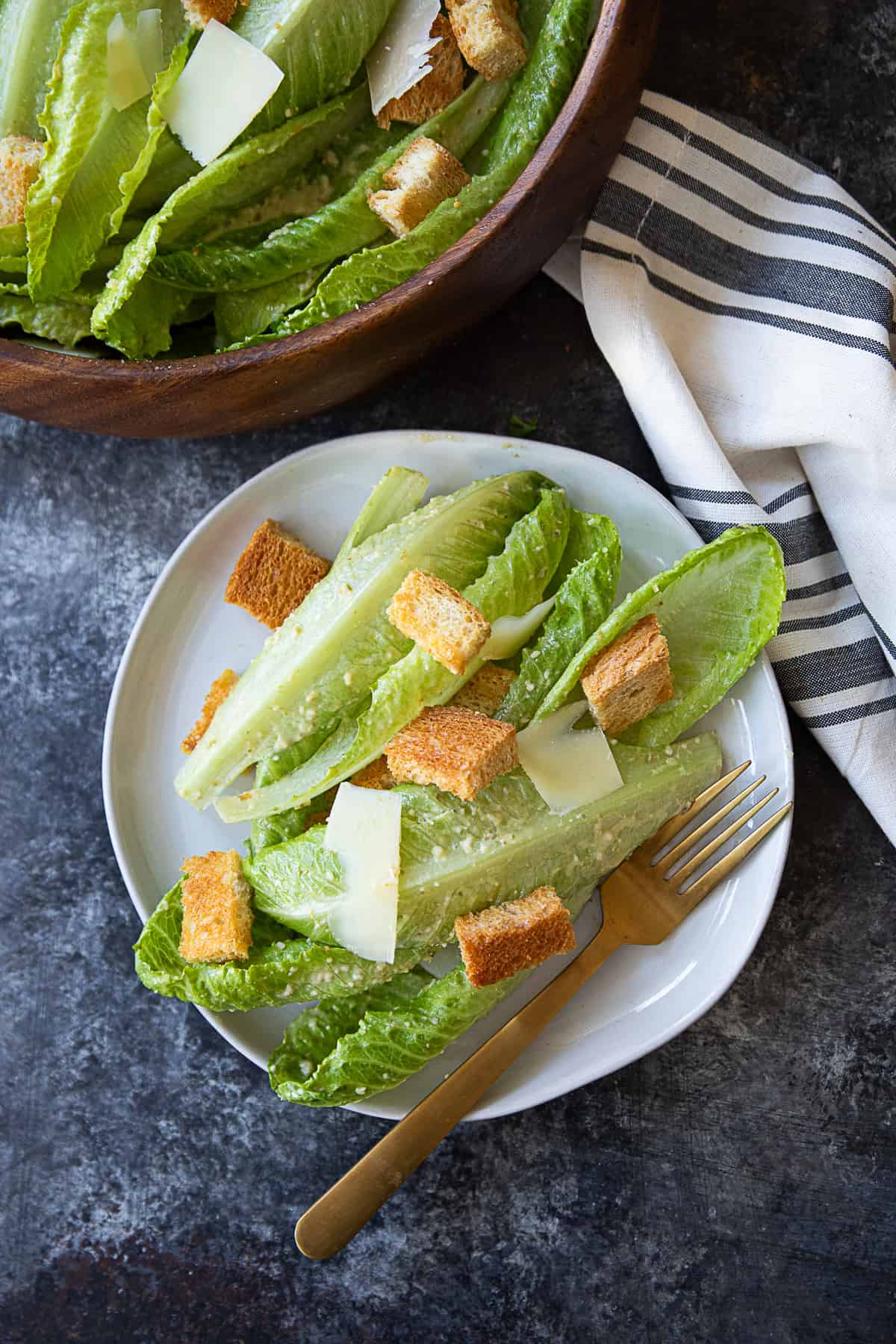 Homemade Caesar salad served in a white dish with homemade croutons