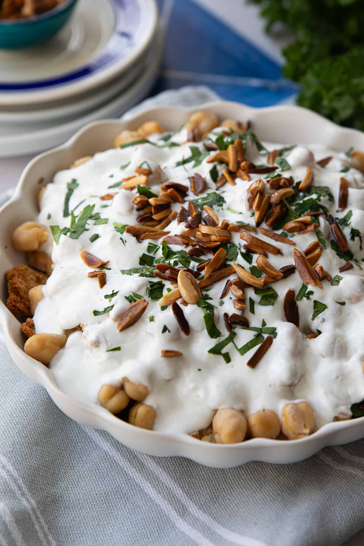 Delicious fatteh recipe featuring layers of golden pita, creamy yogurt, fragrant spices, and toasted almonds, a comforting and satisfying dish perfect for breakfast.