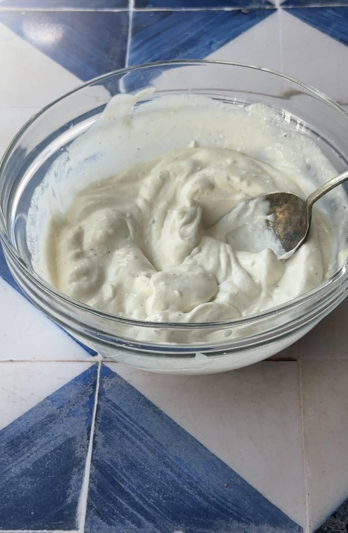 silky fatteh yogurt sauce made up of yogurt, tahini, garlic, and lemon juice