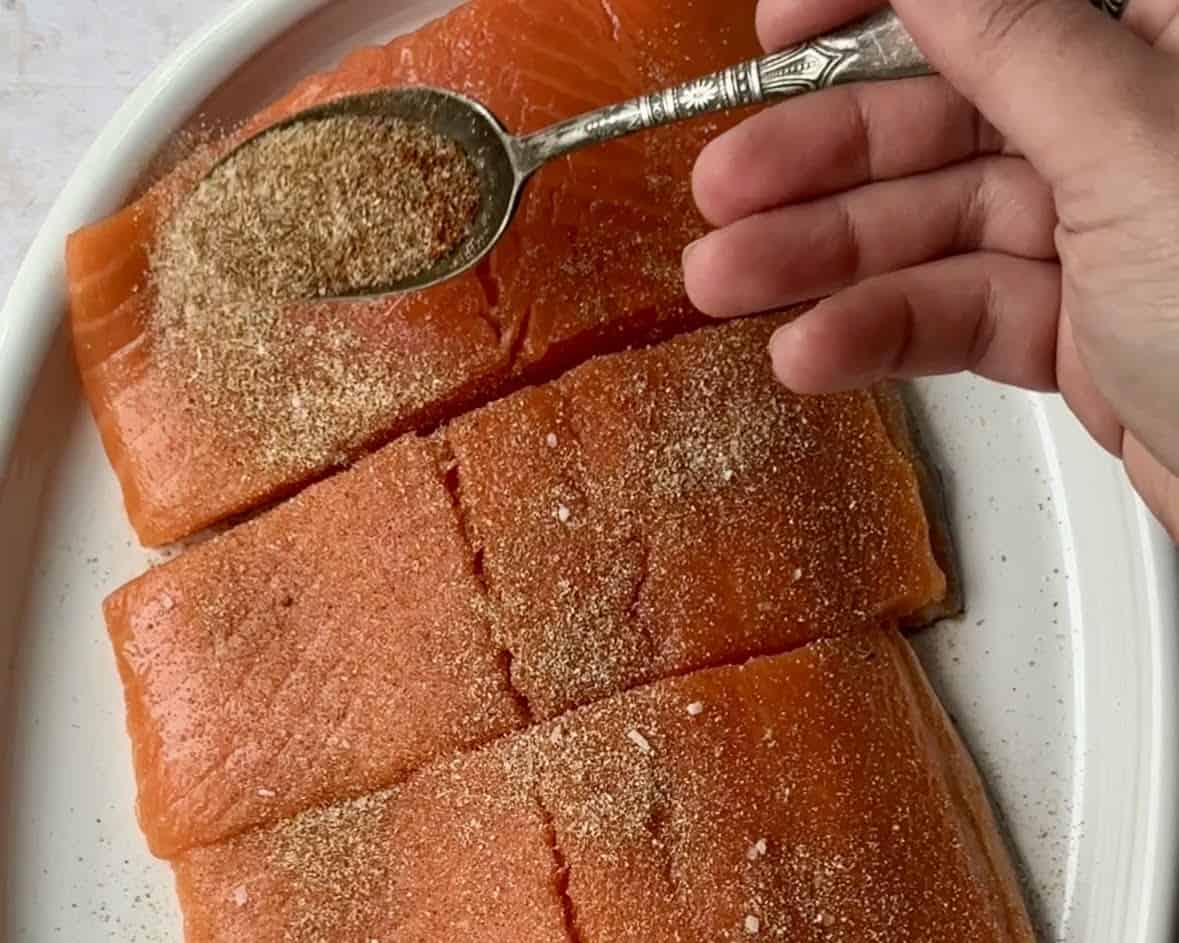 Season the salmon with spices. 