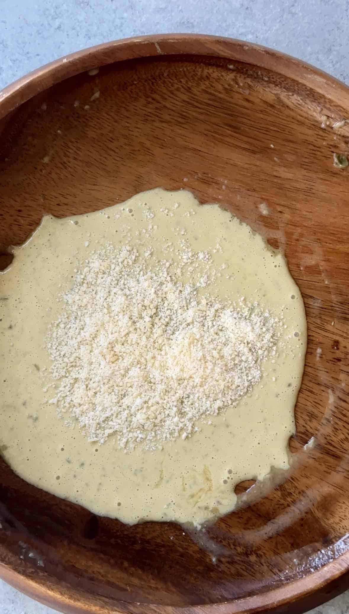 adding parmesan cheese to dressing