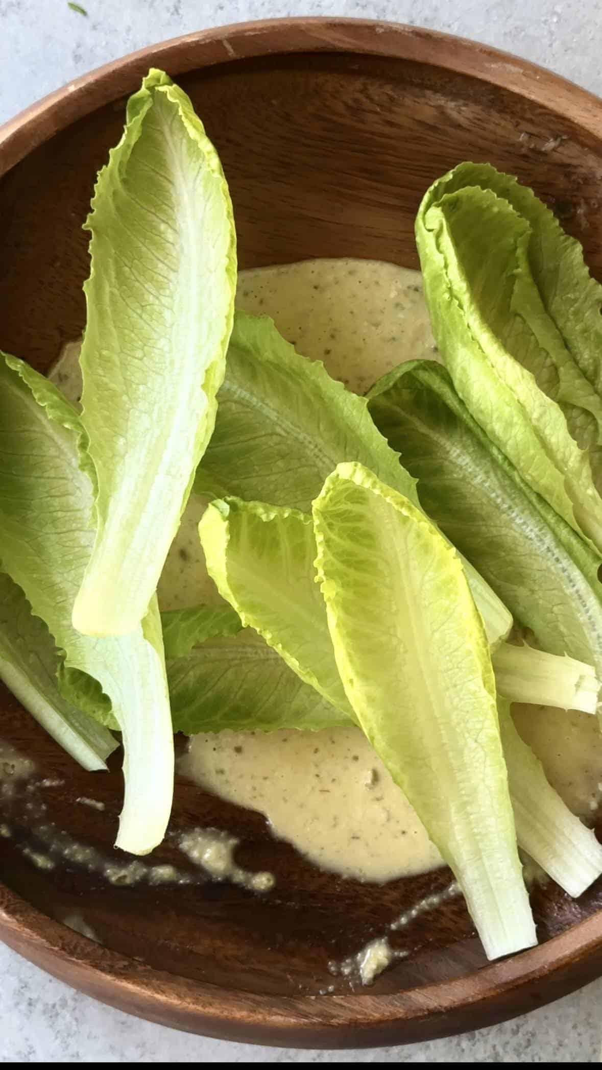 Creamy Caesar Dressing toss romaine lettuce in dressing