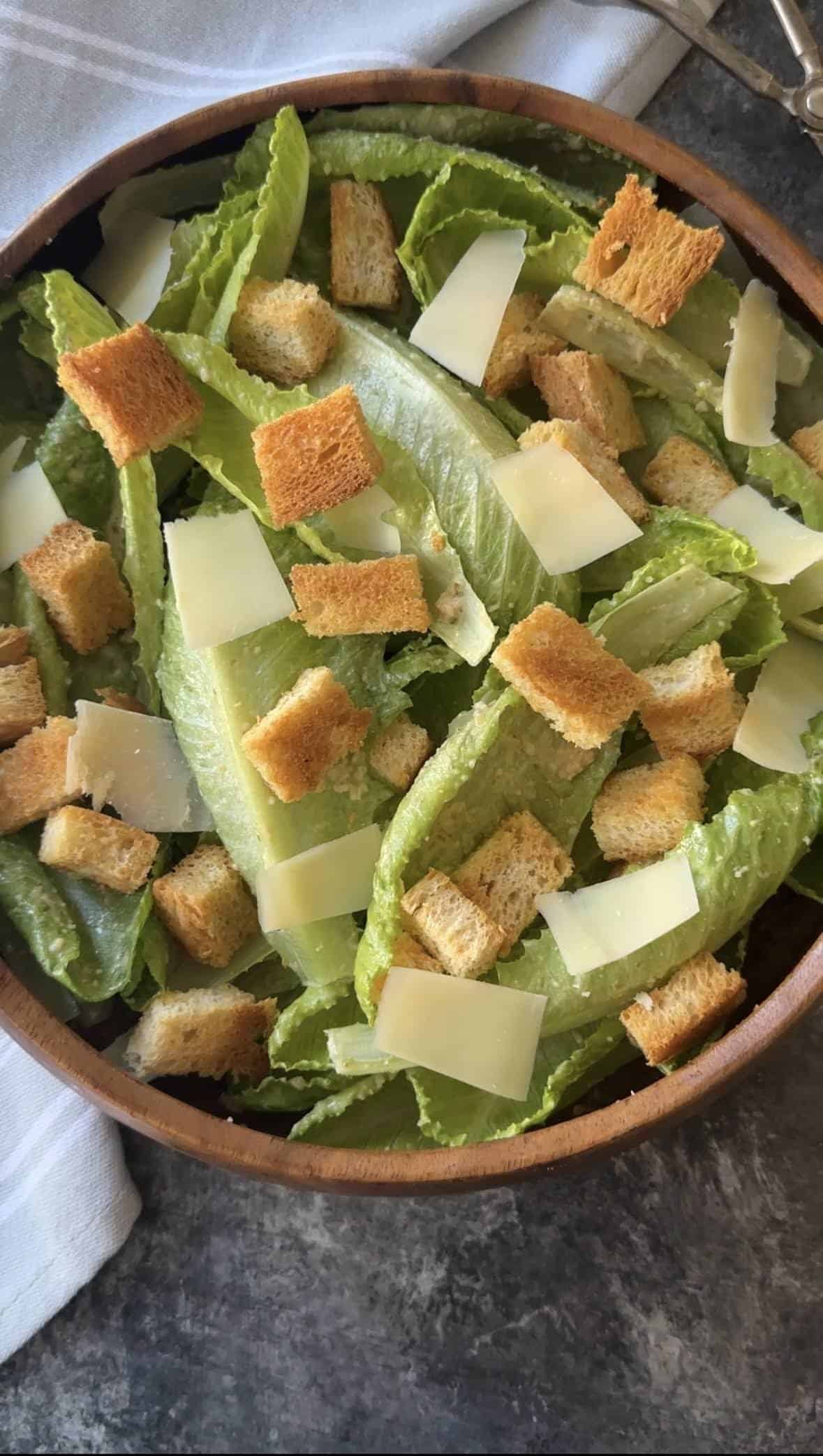 a bowl full of Caesar salad