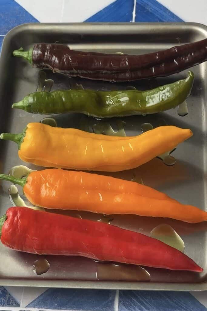 Pepper in a baking sheet topped with olive oil. 