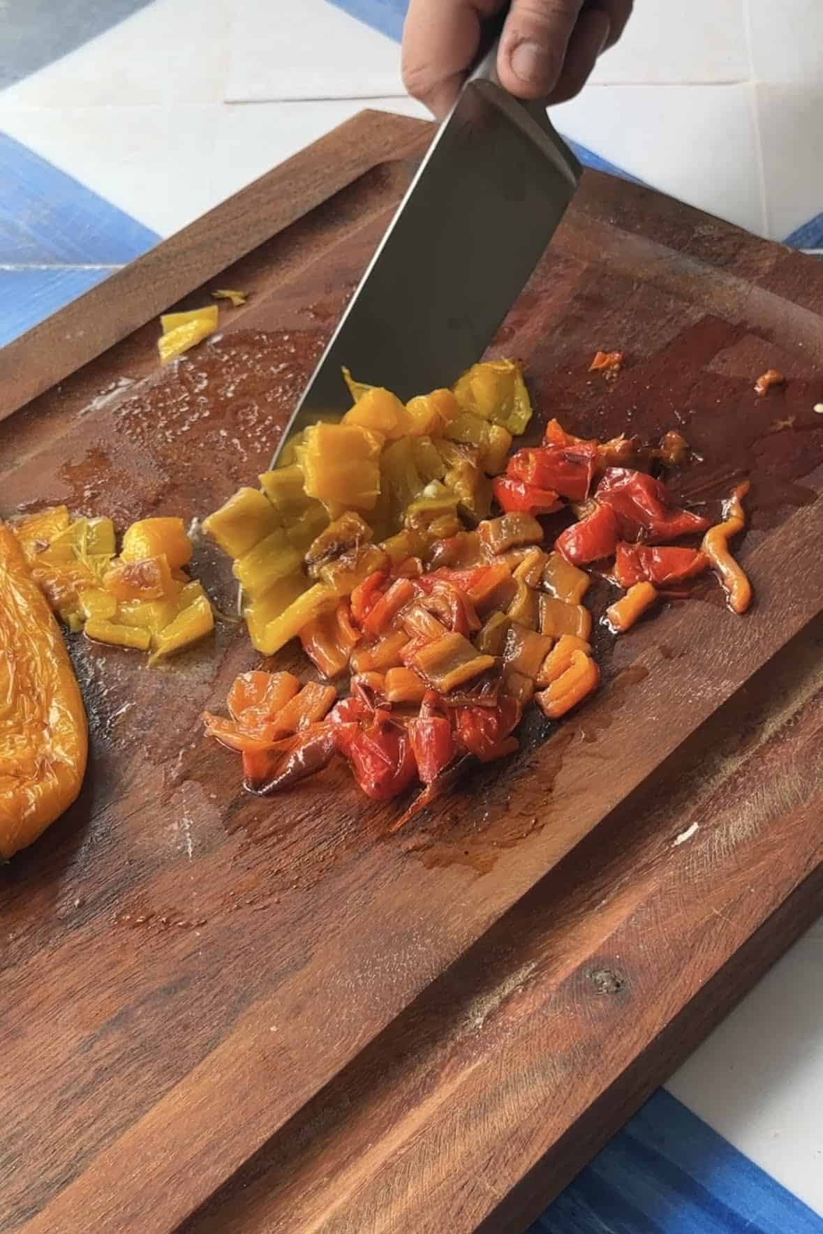 Chopped roasted peppers on a cutting board. 