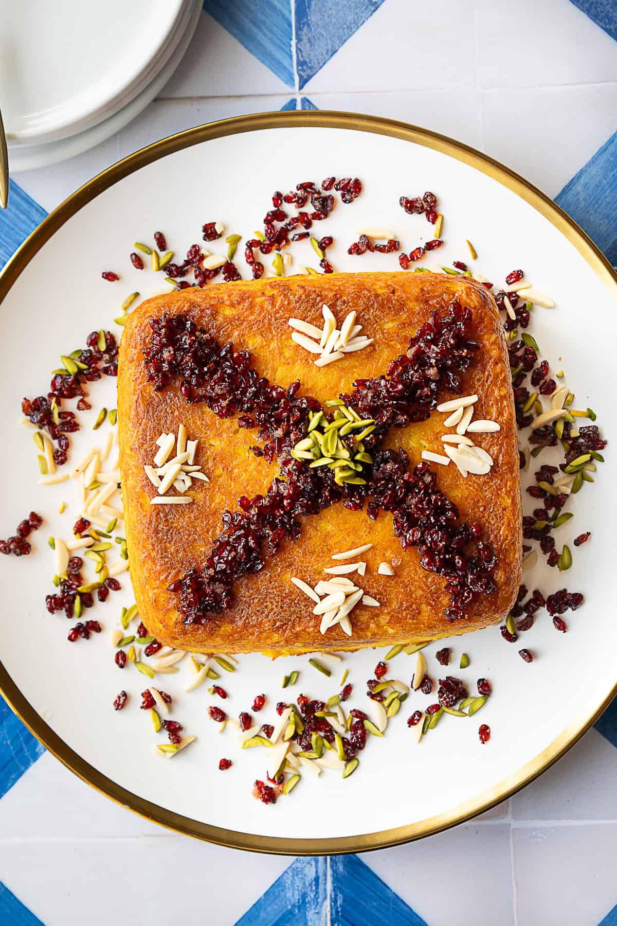 overhead shot of tahchin topped with barberries and pistachios. 