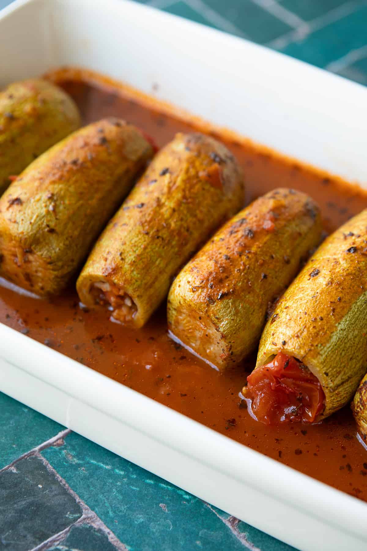 Kabak Dolmasi- Turkish stuffed zucchini with sauce on a classic rectangle white dish