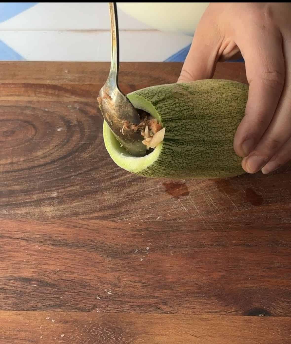 add the stuffing to the cored zucchini