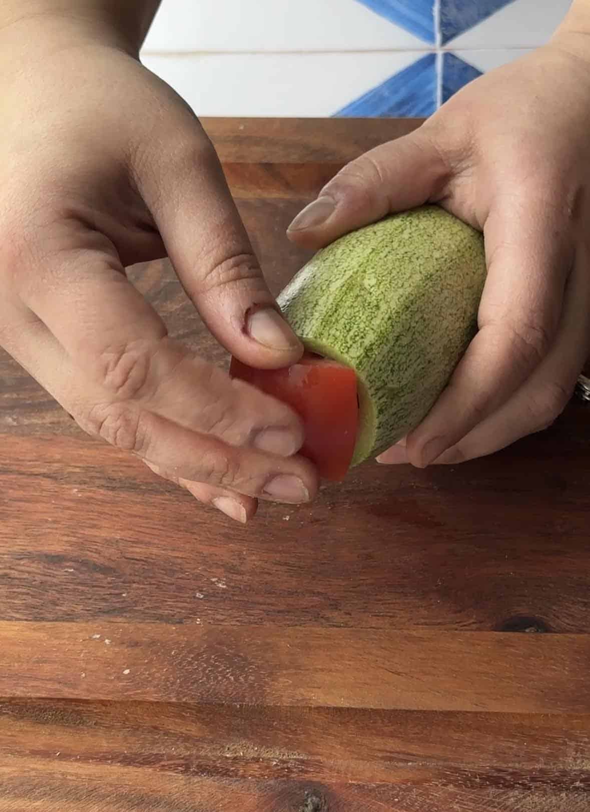 add the tomato chunks to the stuffed zucchini