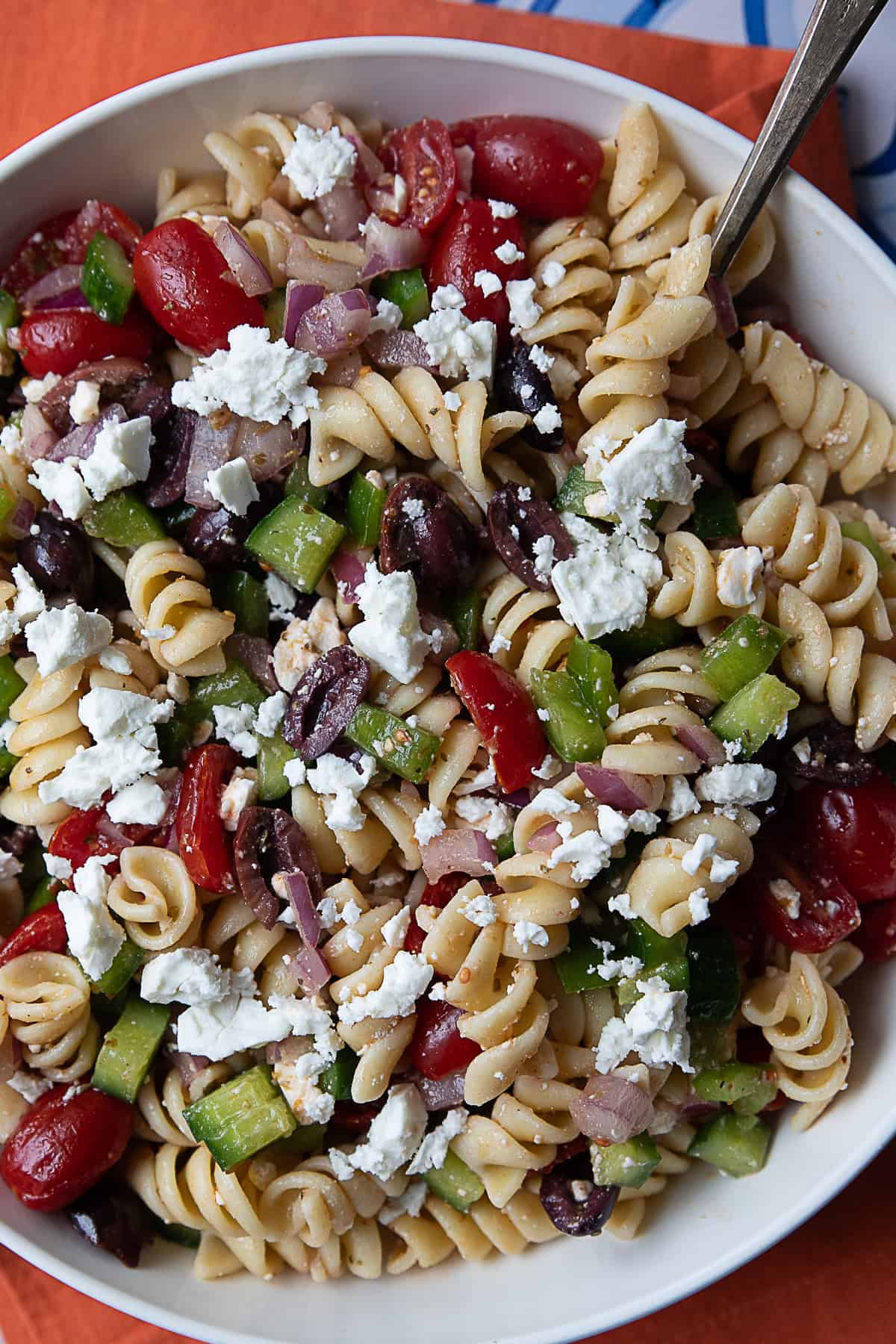 Greek pasta salad: A colorful mix of pasta, tomatoes, cucumbers, red onions, Kalamata olives, and feta cheese, tossed in a tangy Greek dressing.