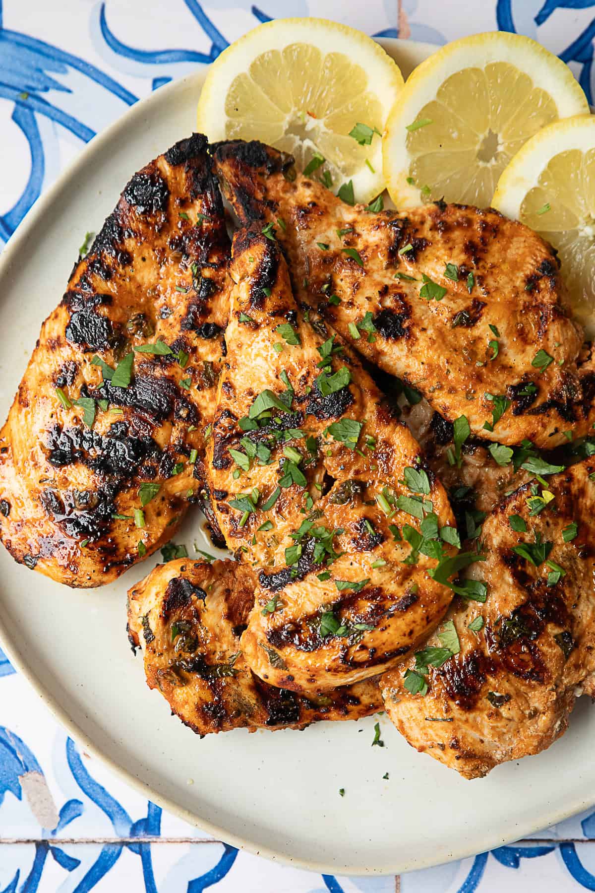 Middle Eastern Grilled Chicken Breast Middle Eastern-inspired grilled chicken breast served on a white platter with sliced lemon rounds