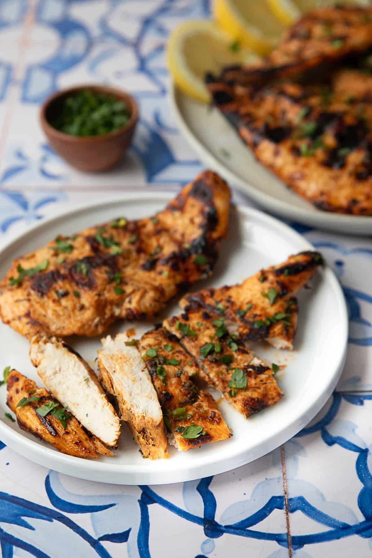 Best Ways to Serve Grilled Chicken Breast Middle Eastern-inspired grilled chicken breast with on piece sliced and served on a white platter